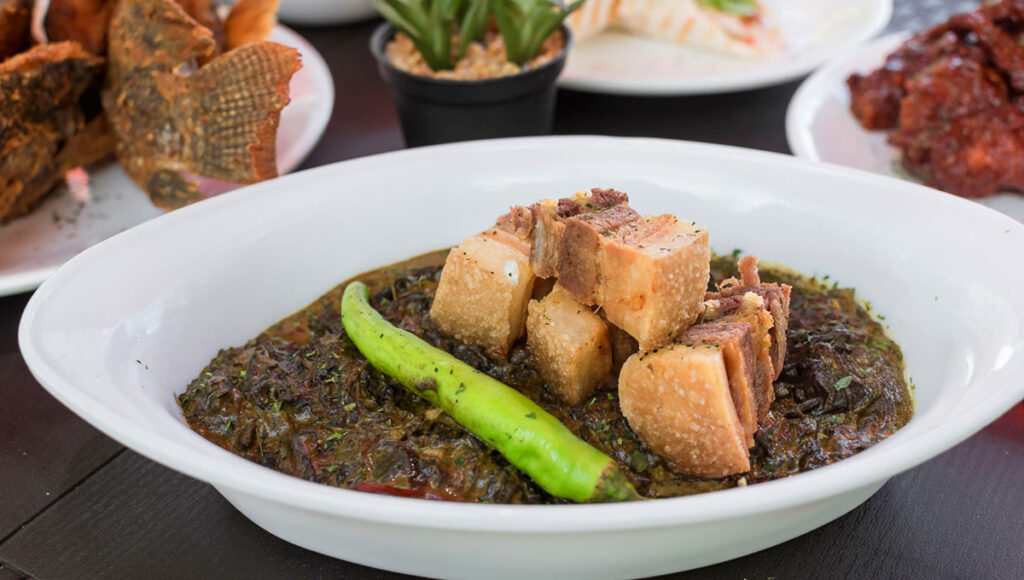 A bowl of Laing made from taro leaves in coconut milk, a spicy and comforting Filipino Christmas food dish