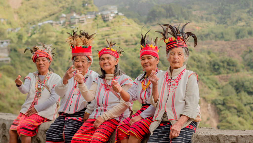 Close-up of friendly Filipino women in traditional dress, demonstrating the warmth and genuine hospitality of the people, which is a key part of what is Philippines famous for.