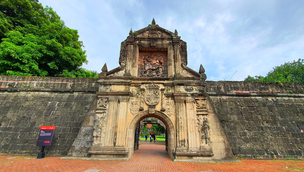 The ornate, historic stone gate entrance to Fort Santiago in Intramuros, a key cultural attraction near Manila.