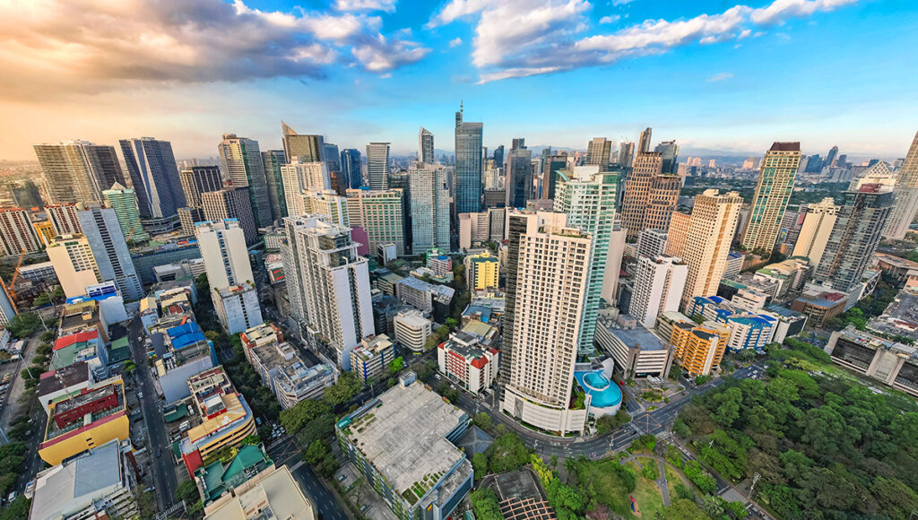 High-angle view of the modern Makati City skyline, the premier business and financial district for where to stay in Manila.