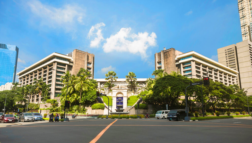 The grand exterior of The Peninsula Manila hotel in Makati, the ultimate luxury choice for where to stay in Manila.