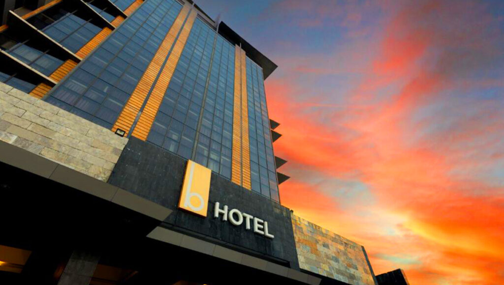 The B Hotel in Bonifacio Global City (BGC) against a fiery sunset, an upscale choice for where to stay in Manila.