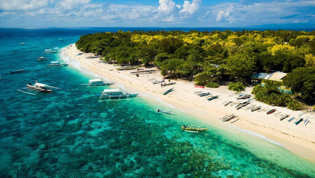 Aerial view of a pristine tropical beach and turquoise sea in the Philippines — a picturesque illustration for travel advice Philippines readers