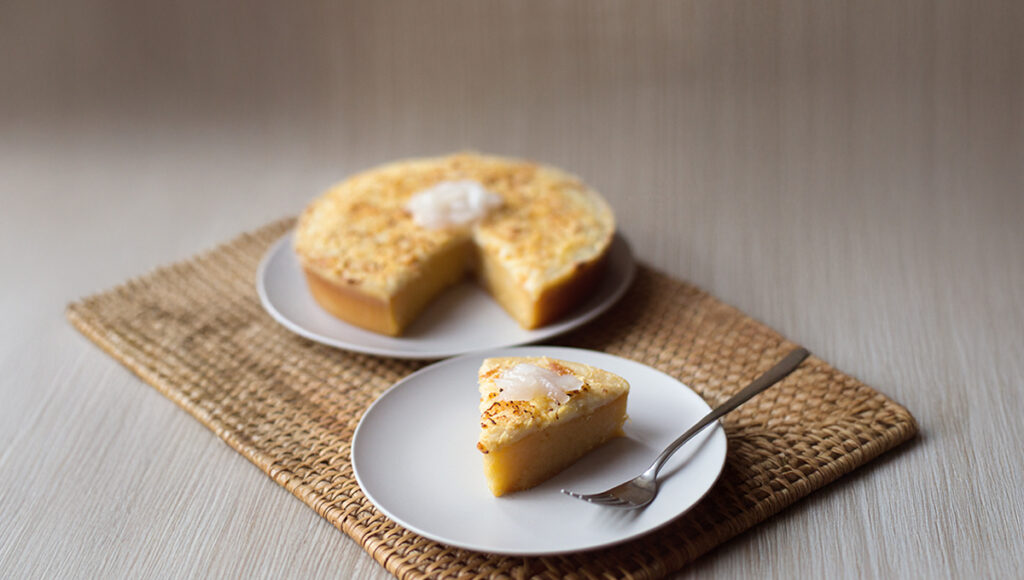 Sweet Filipino desserts cassava cake topped with custard and baked golden.
