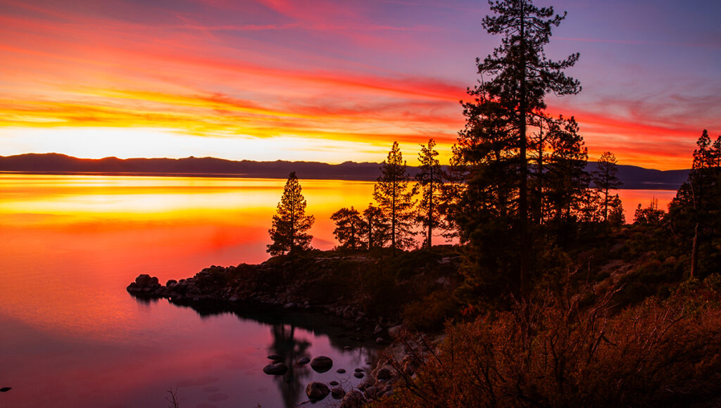 Panoramic mountain view at sunrise with tropical foliage in the Philippines.