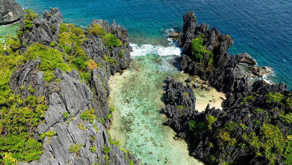 Undiscovered beaches in the Philippines revealed at Secret Beach in El Nido, Palawan hidden behind towering limestone rock formations