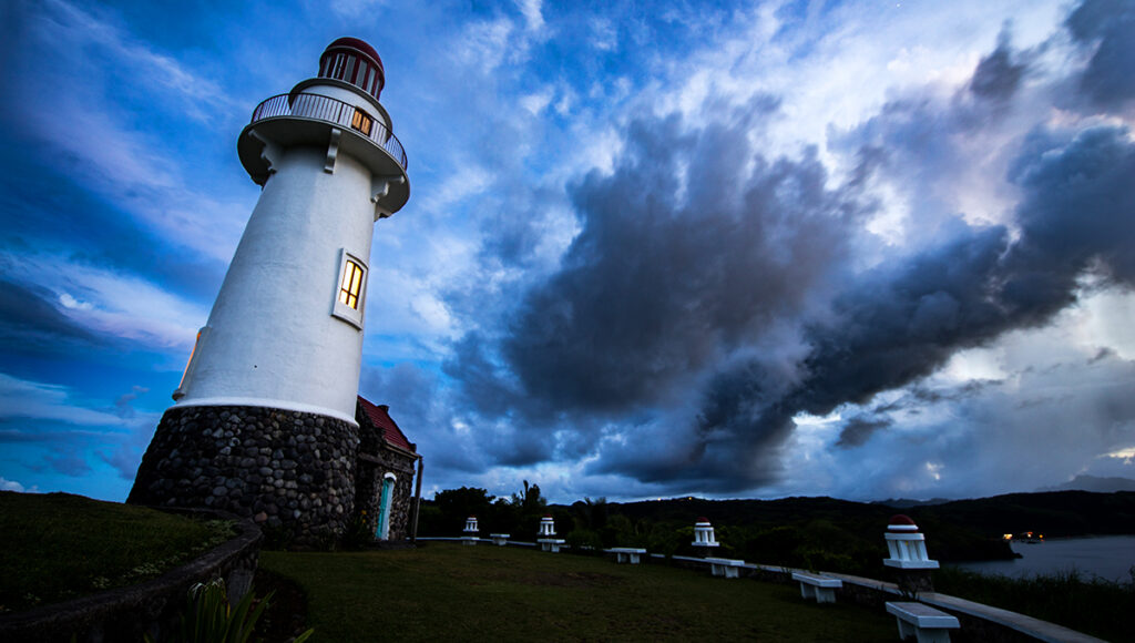 This well-known Batanes tourist attraction features the Basco Lighthouse standing proudly on Naidi Hills, overlooking the town and the surrounding waters. The lighthouse looks bright and striking against the open sky, while the cliffside setting adds a dramatic touch, making it one of the most photographed landmarks in Batanes and a favorite sunset viewing spot.