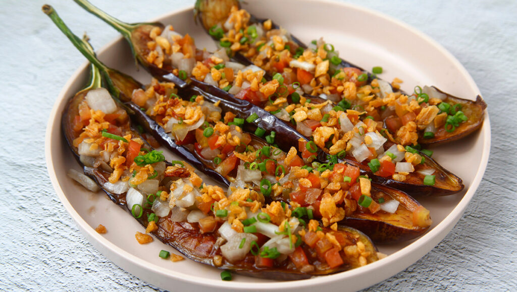 Is Philippines good for vegetarians? Traditional Filipino Ensaladang Talong made with grilled eggplant, tomatoes, and onions.
