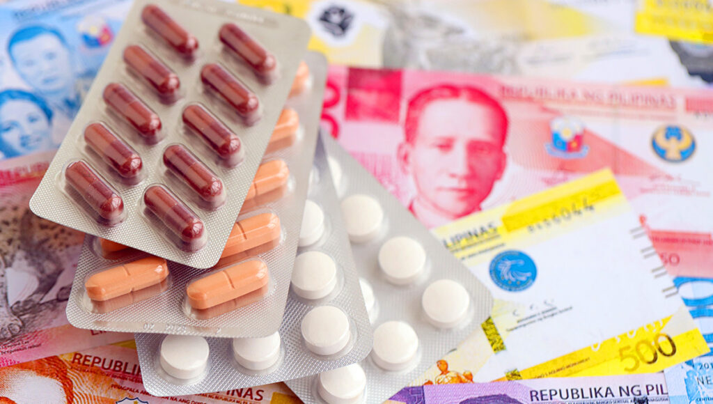 Philippine peso currency money bills with medicine illustrating healthcare costs and cost of living in Philippines.