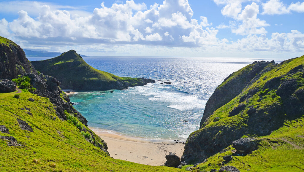 This dramatic Batanes tourist attraction showcases Chamantad-Tiñan Viewpoint on Sabtang Island, where steep green cliffs drop into crystal-clear turquoise waters. The winding ridges and sharp coastal edges create a postcard-like view, giving travellers a feeling of standing at the edge of the world while surrounded by pure natural beauty.