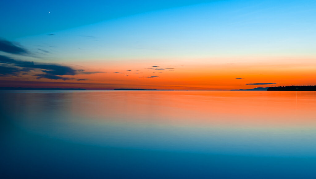 Undiscovered beaches in the Philippines at Naked Island in Siargao with a pristine white sandbar surrounded by vibrant blue ocean.