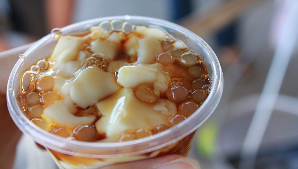 Popular Filipino desserts taho with soft tofu, syrup, and tapioca pearls.
