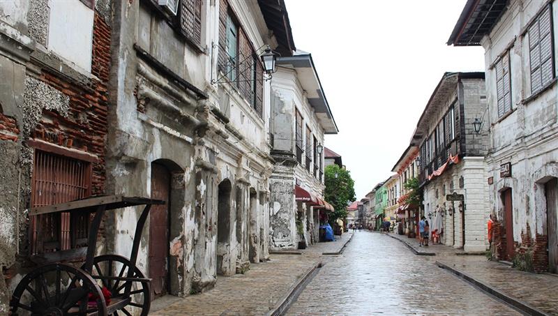 Historic cobblestone street and colonial buildings in Vigan, one of the remarkable historical places in the Philippines showcasing Spanish-era architecture.