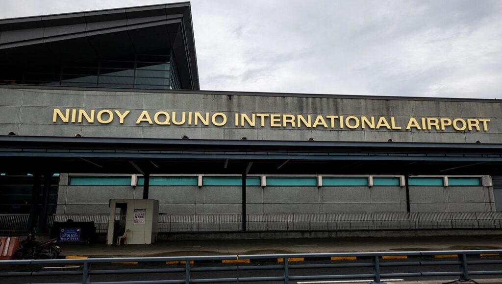 The exterior facade of Ninoy Aquino International Airport (NAIA) in Terminal 3, serving as the main gateway for travelers looking for a Manila airport lounge.