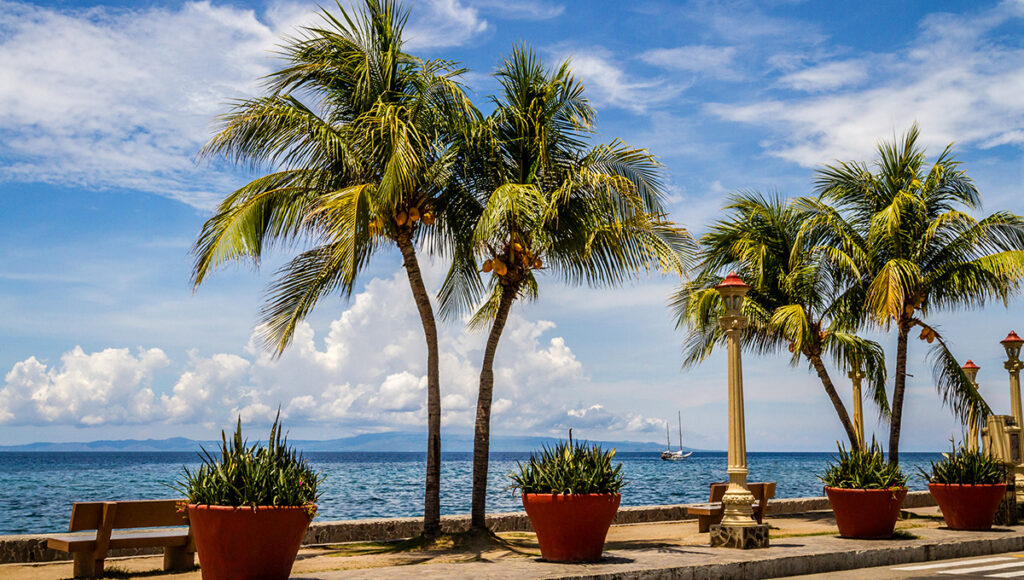 Palm trees and decorative planters lining the Rizal Boulevard waterfront, one of the most popular evening things to do in Dumaguete.