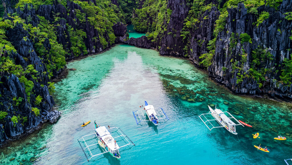 Coron lagoons island hopping boat tour, one of the top things to do in Coron, where you’ll explore hidden lagoons, crystal-clear waters, and stunning limestone islands