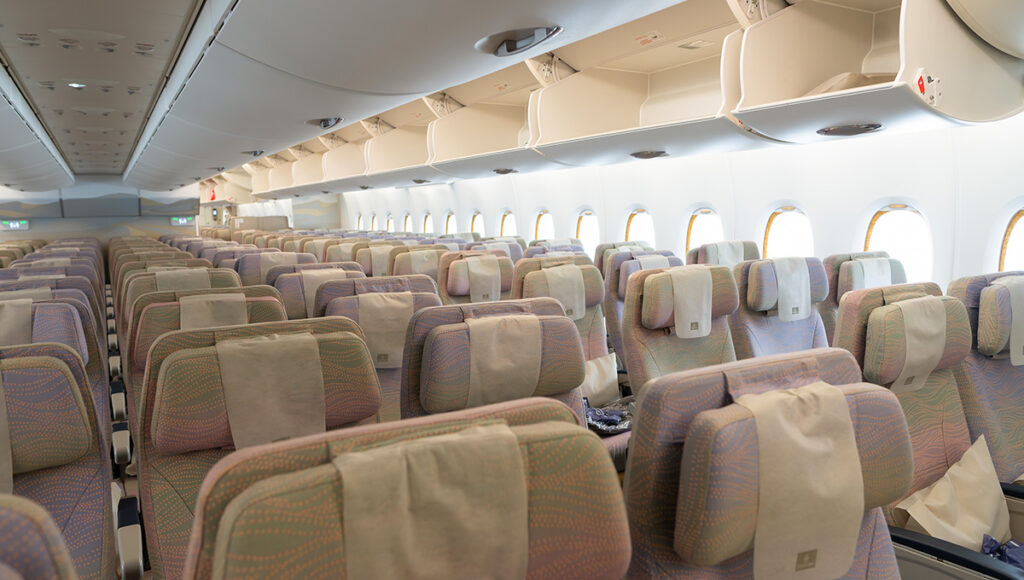 Interior of an Emirates Airbus A380 Economy Class cabin in Bangkok, showing the seating arrangement often used in Qatar Airways vs Emirates comfort comparisons.