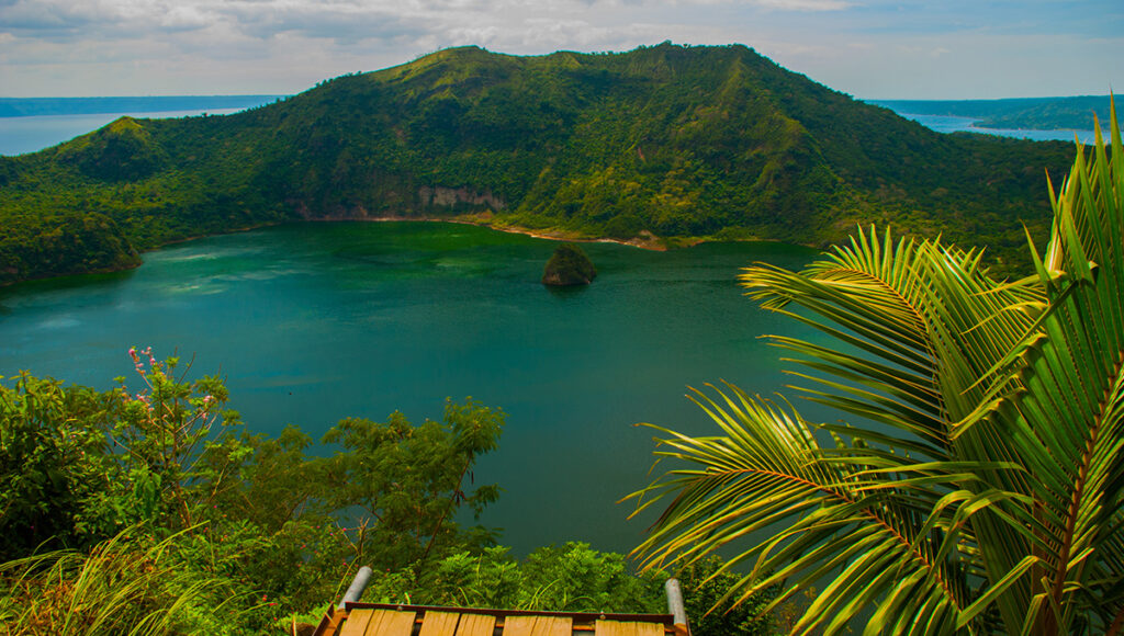 A breathtaking view of the Taal Volcano crater lake from a Tagaytay ridge, one of the most famous and scenic day trips from Manila.