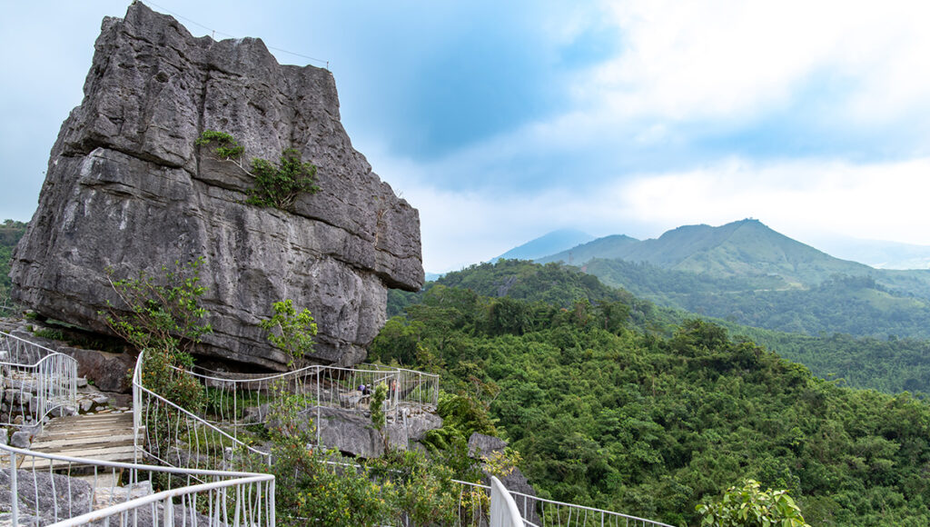 A massive limestone karst formation and winding trail at Masungi Georeserve in Rizal, perfect for eco-adventure day trips from Manila.