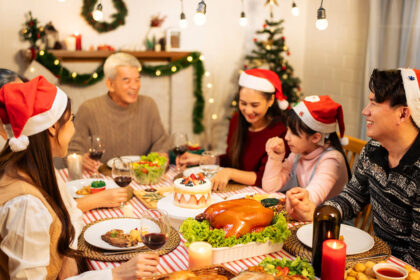 A Filipino family celebrating Christmas at home with traditional Filipino Christmas food around a festive dining table