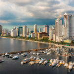 Picture of Manila Bay skyline with yachts at a marina, showing where to stay in Manila near the waterfront.