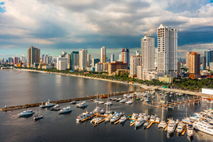 Picture of Manila Bay skyline with yachts at a marina, showing where to stay in Manila near the waterfront.