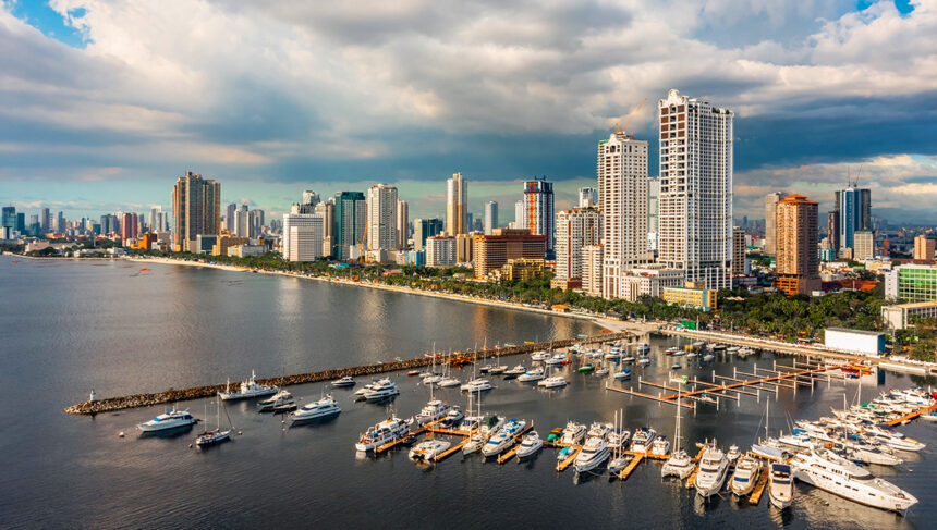 Picture of Manila Bay skyline with yachts at a marina, showing where to stay in Manila near the waterfront.