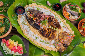 Grilled seafood and meats served on banana leaves during a traditional Boodle Fight Philippines feast.