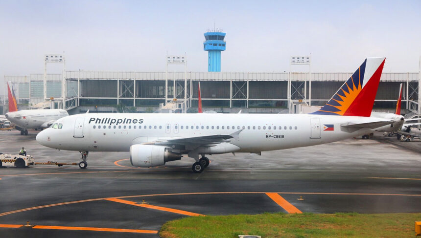 Philippine Airlines airplane parked at Manila airport, with passengers preparing their luggage according to Philippines Airlines baggage allowance rules.