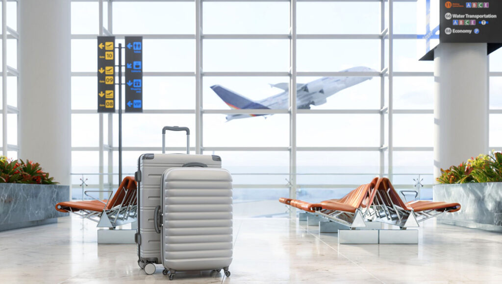 Two suitcases placed in an airport waiting area with empty seats, illustrating Philippines Airlines baggage allowance for travelers.