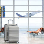 Two suitcases placed in an airport waiting area with empty seats, illustrating Philippine Airlines baggage allowance for travelers.