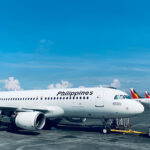 View of several commercial aircraft parked at Manila Ninoy Aquino International Airport, reflecting the busy hub many passengers fly into when booking the cheapest flight to the Philippines.