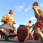 Filipino traditional dance performed during a street festival in Dumaguete City, Negros Oriental, with dancers wearing vibrant costumes and showcasing coordinated movements that reflect local heritage
