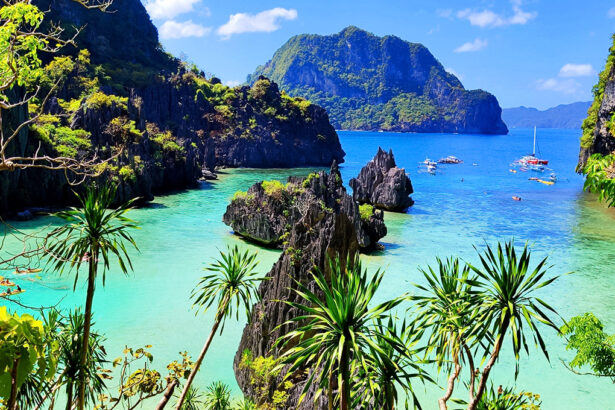 Tropical turquoise waters and limestone karst formations at one of the famous Palawan beaches in El Nido.