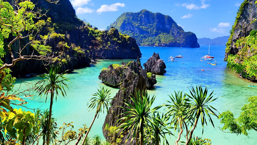Tropical turquoise waters and limestone karst formations at one of the famous Palawan beaches in El Nido.