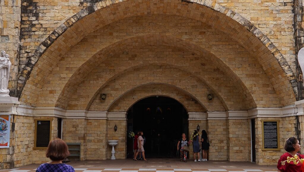 Walking through the stone arch entrance of Our Lady of the Cathedral in Zamboanga Del Norte, one of the iconic places to visit in Zamboanga