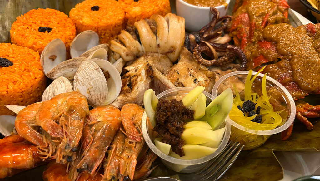 Fresh seafood platter with grilled fish, shrimp, and squid in Zamboanga, where coastal dining experiences make these unforgettable places to visit in Zamboanga for beachside meals