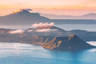 A stunning sunset view of Taal Volcano and Lake, one of the most iconic things to do in Tagaytay.