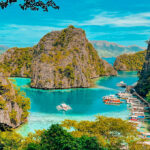 An aerial view of the turquoise waters at Kayangan Lake, Palawan, highlighting the clear visibility often enjoyed during the hot Philippines weather May.