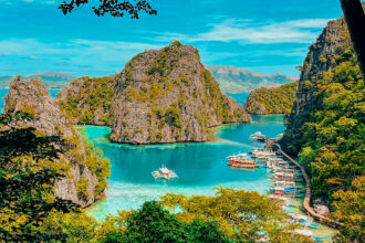 An aerial view of the turquoise waters at Kayangan Lake, Palawan, highlighting the clear visibility often enjoyed during the hot Philippines weather May.