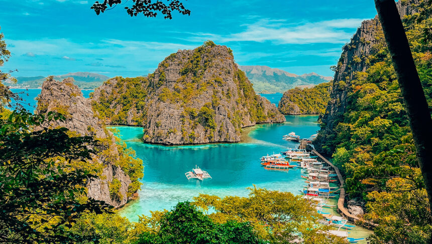 An aerial view of the turquoise waters at Kayangan Lake, Palawan, highlighting the clear visibility often enjoyed during the hot Philippines weather May.