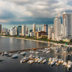 An aerial view of yachts docked at the Manila Yacht Club with the city skyline in the background under the hazy afternoon Philippines weather in March.