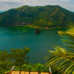 A breathtaking view of the Taal Volcano crater lake from a Tagaytay ridge, one of the most famous and scenic day trips from Manila.