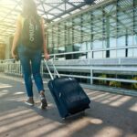 Woman walking with luggage outside an airport for a Philippines Travel Guide