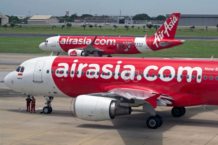 AirAsia Philippines Baggage Allowance guide featuring AirAsia aircraft on an airport runway