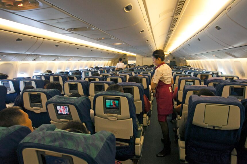 Flight attendant assisting passengers while travelling on cheap domestic flights Philippines