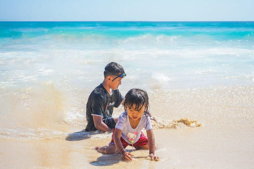 Children playing by the shore during a Philippines family holiday