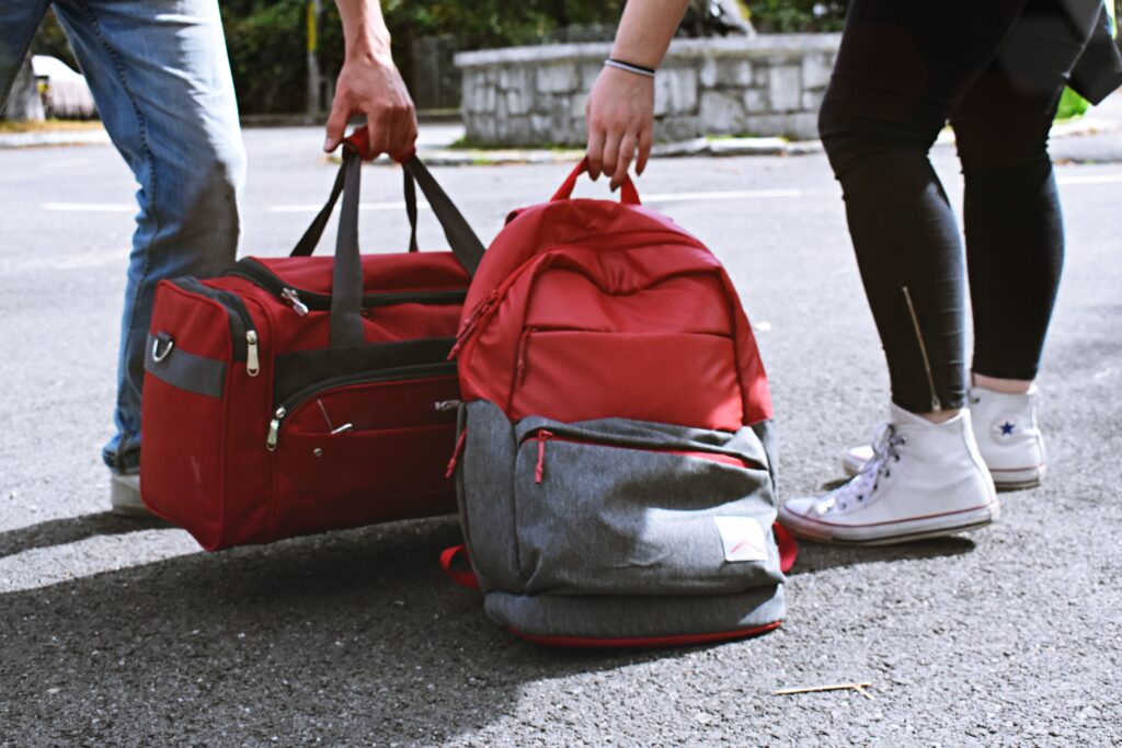 Two travellers carrying bags while exploring Cebu Pacific Baggage Allowance guidelines