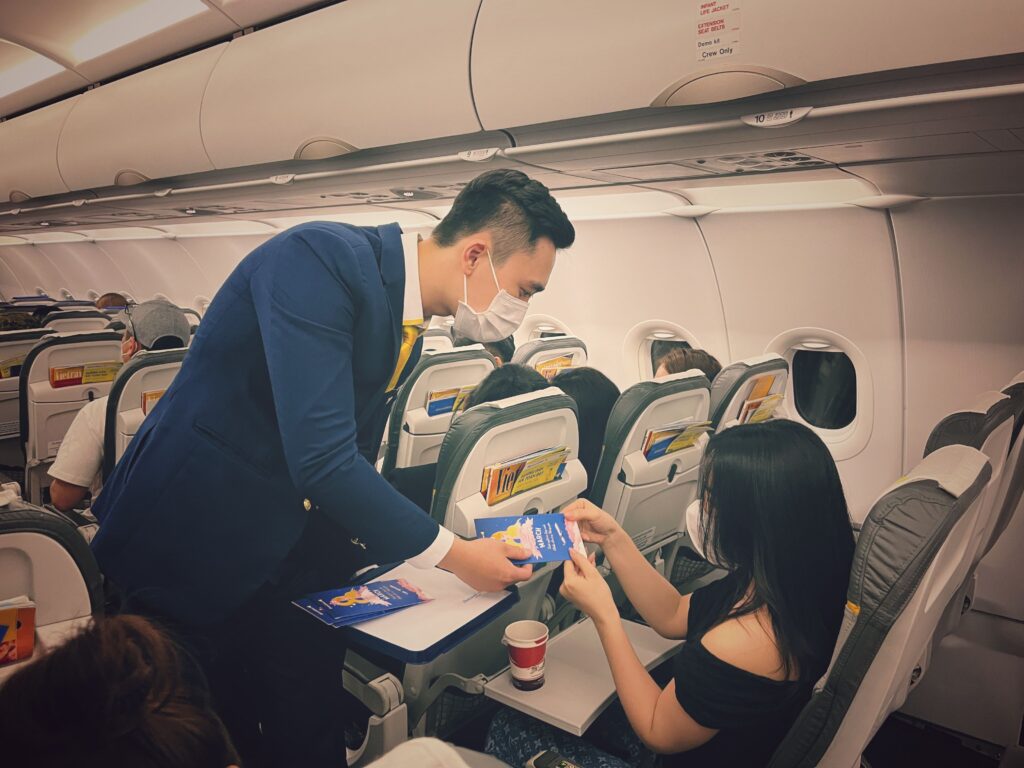 Cabin crew serving passengers while travelling on cheap domestic flights Philippines