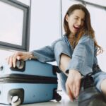 Cheerful young woman with luggage, highlighting Cebu Pacific Baggage Allowance travel tips